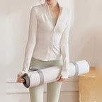 Mulher com casaco de treino Bhakti Cover branco e tapete de yoga – lifestyle