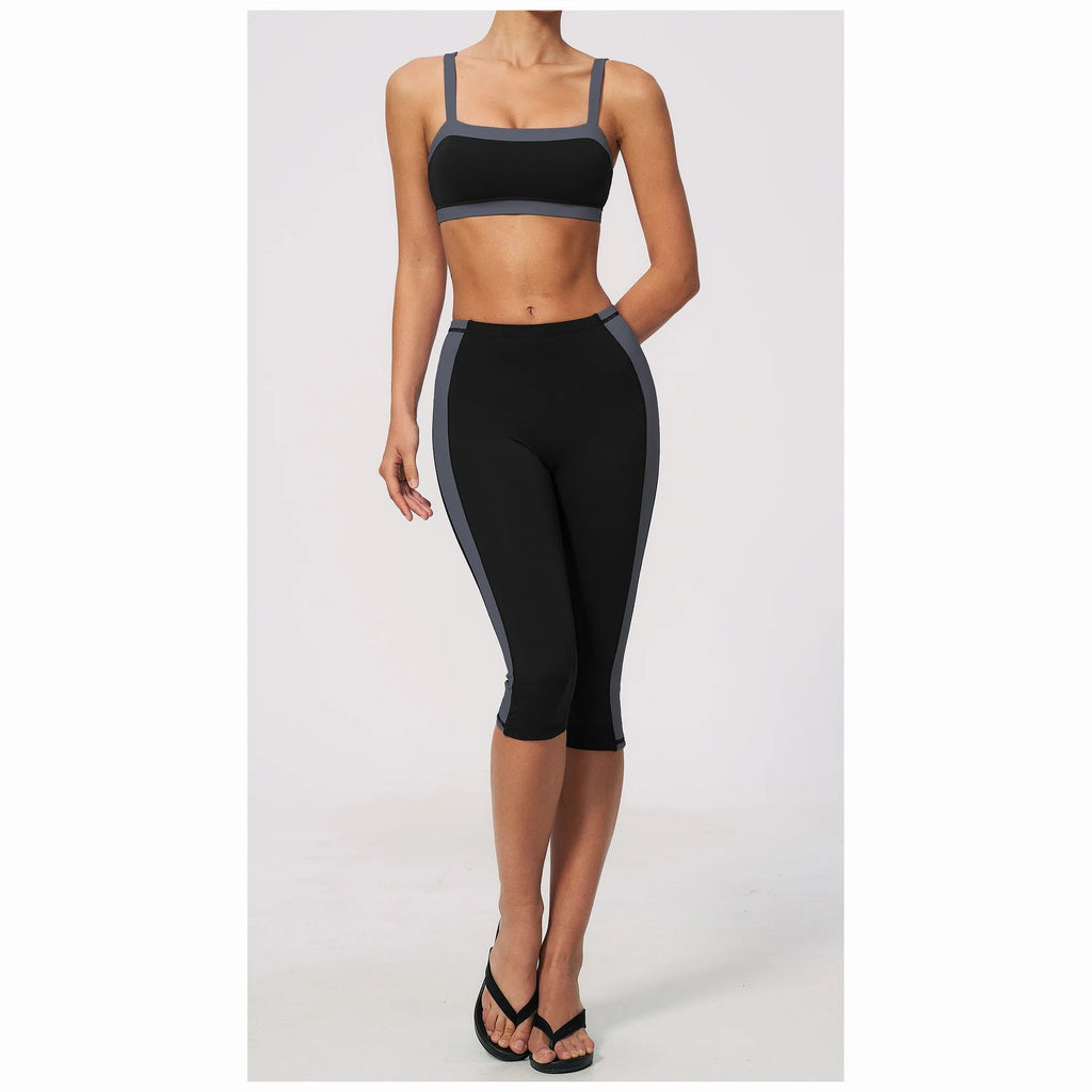 Conjunto Vinyasa Motion preto com top cavado e leggings capri – vista de frente