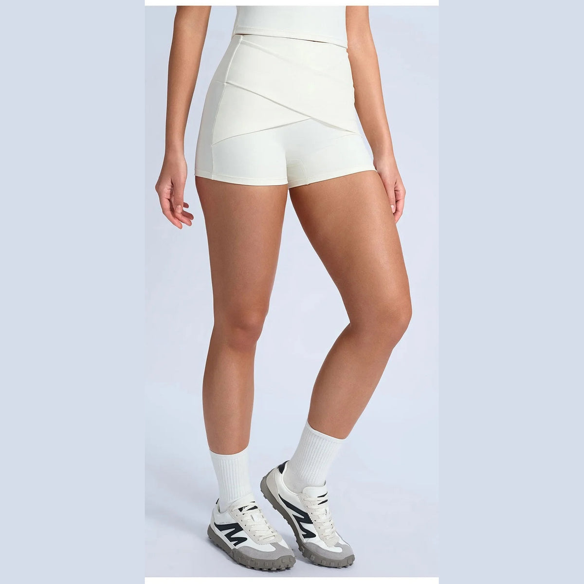 Calções Shakti Move branco-bege com ténis – vista de frente