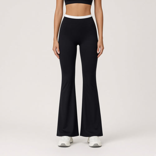 Ruach Flow – Calças de Yoga Boca de Sino de Cintura Subida, cor Preto, vista de frente com cós branco contrastante, fundo estúdio